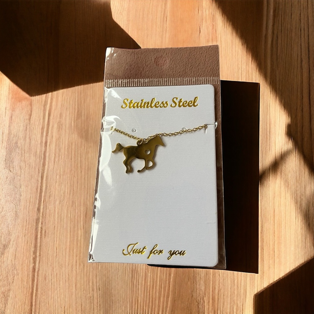 Gold-tone Fashion Jewelry horse necklace. New. Never worn.